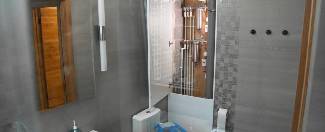 Modern Maryland bathroom with tiled walls, updated fixtures, and accessible plumbing panel