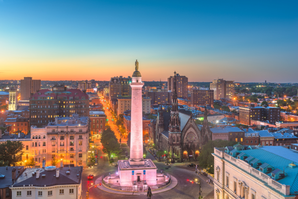 Baltimore skyline at sunset highlighting urban neighborhoods served by modular home construction and home remodeling services.