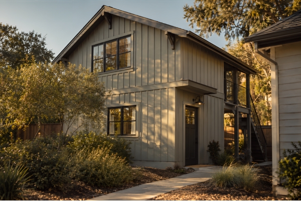 In-Law Suites and Aging in Place ADUs Small second-story unit with a covered porch above a garage.